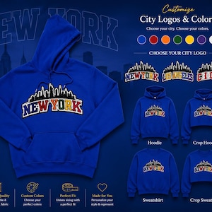 May include: A royal blue hooded sweatshirt featuring a black city skyline silhouette graphic above the text NEW YORK in multi-colored letters. The image displays customization options for city logos, colors, and garment styles including hoodies and sweatshirts.