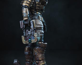 May include: A detailed statue of a futuristic armored figure, predominantly bronze and gray, with glowing teal accents on the helmet. The figure holds a weapon and stands on a textured base, set against a dark background.