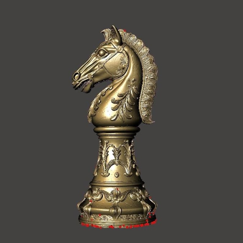 May include: A gold-colored chess knight piece. The knight is highly detailed with a horse head design, mane, and ornate base. The piece is a decorative item, likely for display or a chess set.
