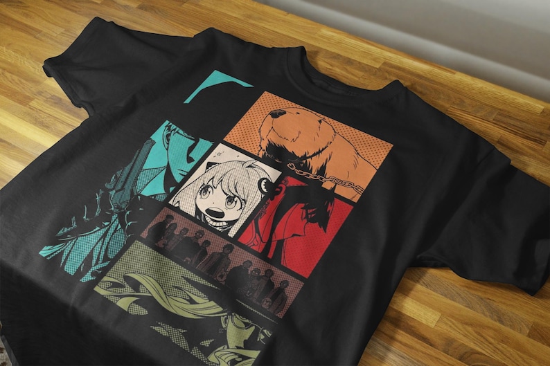 May include: Black t-shirt featuring a colorful comic-style graphic. The design includes panels with characters and a bear. The shirt is made of a soft material and is suitable for casual wear.