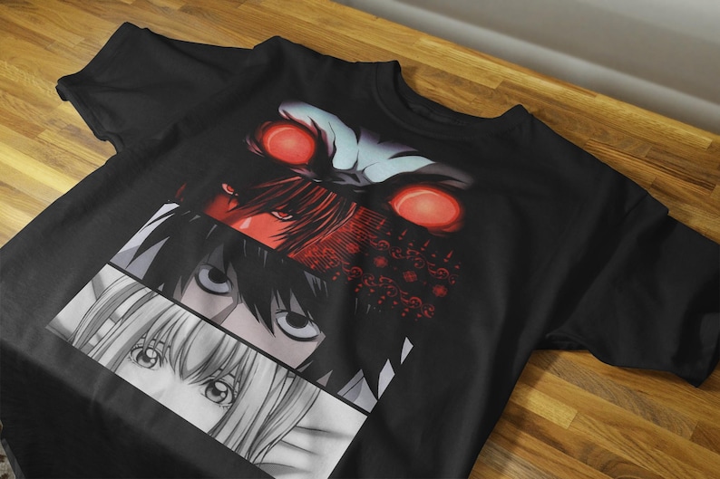 May include: Black t-shirt featuring a graphic design of anime character eyes in red, black, and white. The design is split into three horizontal sections. The top section has red eyes and a dark background.
