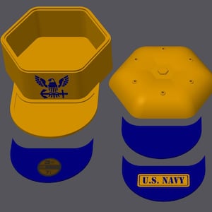 May include: A disassembled yellow and blue U.S. Navy hat. The hat features a hexagonal crown, a curved brim, and a blue emblem with the text "U.S. NAVY". The hat also has a blue emblem with an eagle, anchor, and cross.