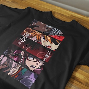 May include: Black t-shirt featuring a colorful anime-style graphic. The design includes multiple character portraits and Japanese text. The shirt is made of a soft material and is suitable for casual wear.