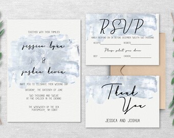 May include: A wedding invitation suite with a blue watercolor background. The invitation features the couple's names, "Jessie Lynn & Joshua Levin", the date and time of the wedding, and the location. The RSVP card includes a space for guests to indicate their attendance and meal choice. The thank you card features the text "Thank You" and the couple's names.
