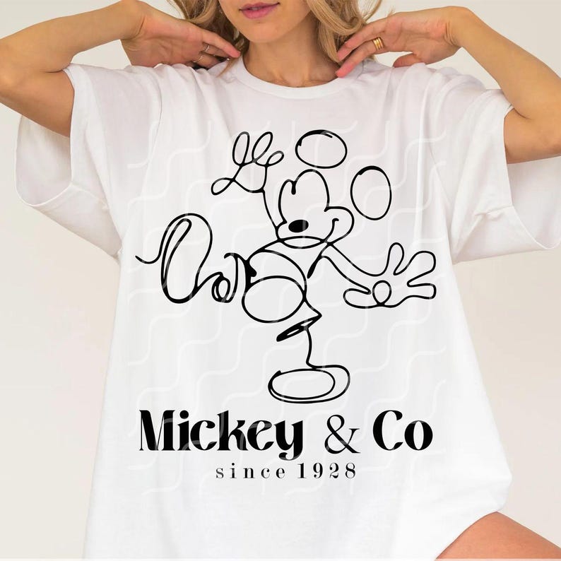 May include: White t-shirt with a black line drawing of Mickey Mouse and the text "Mickey & Co. since 1928"