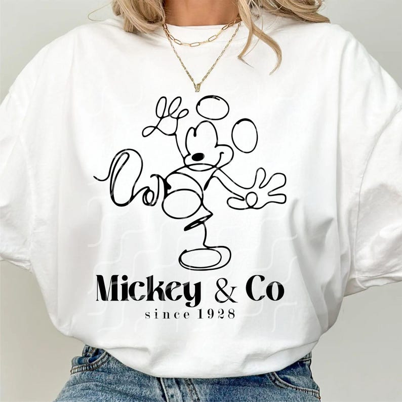 May include: White t-shirt with a black line drawing of Mickey Mouse and the text "Mickey & Co since 1928"
