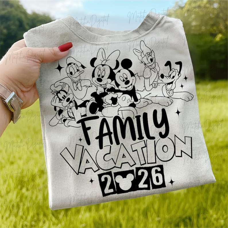 May include: A light gray sweatshirt featuring a black and white graphic of Disney characters, including Mickey and Minnie Mouse, Donald Duck, and Goofy. The text "FAMILY VACATION 2026" is printed below the characters.