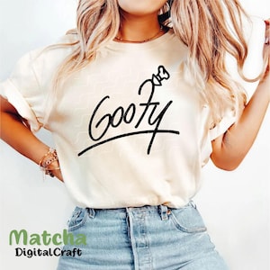 Puede incluir: Una camiseta blanca con un gr&aacute;fico negro de la palabra "Goofy" en un estilo de escritura a mano con una imagen de dibujos animados del sombrero de Goofy sobre la palabra.
