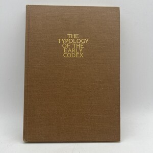 May include: A brown book with the title "The Typology of the Early Codex" printed in gold lettering on the front cover.