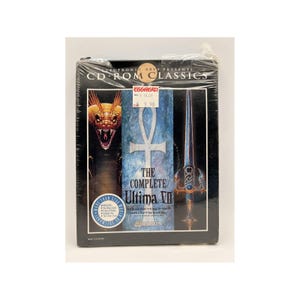May include: A CD-ROM case for the game "The Complete Ultima VII" by Electronic Arts. The case is black with a blue and white design. The game features the Black Gate, the Serpent's Isle, and the Savage Empire. The case is shrink-wrapped and has a price tag from Egghead Software.