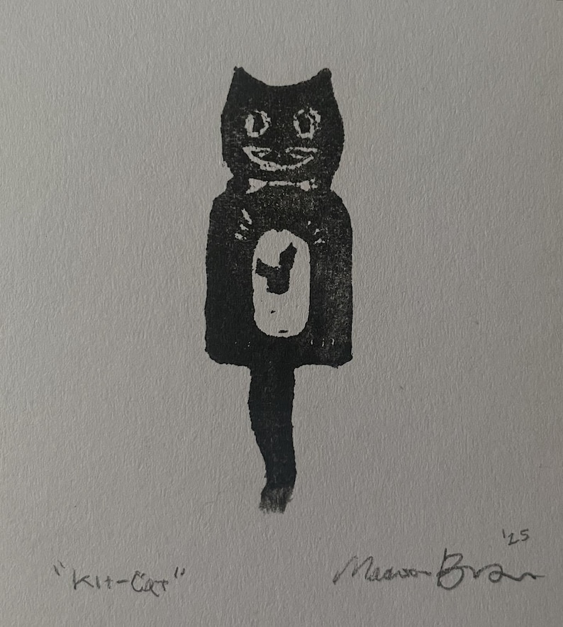 May include: A black and white block print illustration of a stylized cat clock with a long tail. The cat has a white oval on its chest and a bow tie. The text "Kit-Cat" is printed on the bottom left, and the signature with "'25" is on the bottom right.
