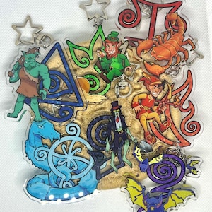 May include: A collection of clear acrylic keychains featuring colorful cartoon illustrations of a green ogre, a leprechaun, a scorpion, a blue serpent, a zombie in a top hat, and purple bats, each attached to a silver star-shaped metal clasp.