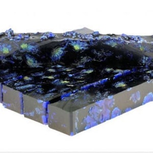 May include: A stack of blue and black resin blanks with a swirling pattern. The resin is translucent and has a speckled appearance.