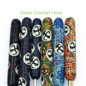 May include: Six Clover crochet hooks with different colored and patterned handles. Each handle features a white circle with a black dragon silhouette.