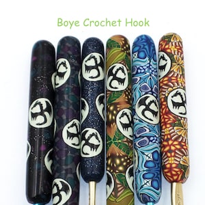 May include: Six Boye crochet hooks with different colored and patterned handles. Each handle features a white dragon silhouette.