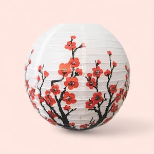 May include: A spherical white paper lantern adorned with red cherry blossom designs. Black branches support the red flowers. This decorative lantern is suitable for various settings, adding a touch of elegance.