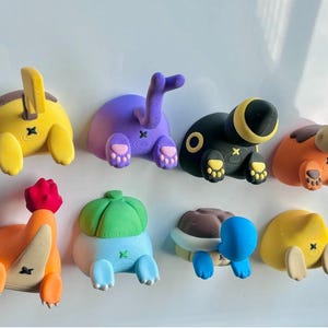 Könnte beinhalten: Ein Set mit acht bunten Charaktermagneten im Cartoon-Stil. Jeder Magnet zeigt einen anderen Charakter mit einem einzigartigen Design und einer einzigartigen Pose. Die Magnete sind aus einem strapazierfähigen, hochwertigen Material gefertigt und perfekt, um jedem Kühlschrank oder jeder Metalloberfläche einen Hauch von Spaß zu verleihen.