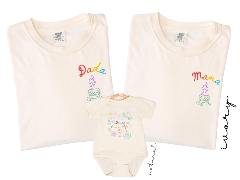May include: Two ivory t-shirts and one natural baby bodysuit. The t-shirts feature embroidered text reading Dada and Mama above a birthday cake graphic. The bodysuit displays colorful party graphics and the text Ready two party!