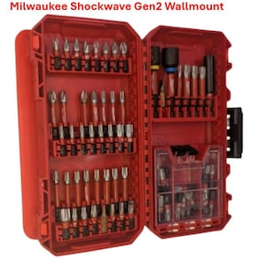 May include: Open red tool case with various drill bits and accessories. The case is labeled "Milwaukee Shockwave Gen2 Wallmount" and "Made in Germany". The case is open, revealing multiple compartments filled with bits of different sizes and shapes.