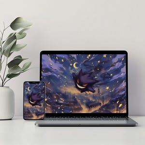 May include: A laptop computer with a dark purple and black ghost character flying through a night sky with stars and a crescent moon. The laptop is on a white surface with a small potted plant to the left.