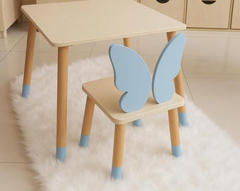 May include: A light wood children's table and chair set with butterfly-shaped backrests on the chair. The chair and table legs are painted a light blue color.