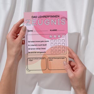 May include: A pink and peach-colored teacher's report card with German text, held by hands. The report card has sections for name, class, and feedback, with smiley face ratings and space for comments. The text includes phrases like "good mood" and "fun lessons."