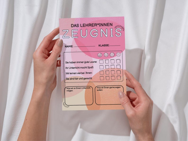 May include: A pink and peach-colored teacher's report card with German text, held by hands. The report card has sections for name, class, and feedback, with smiley face ratings and space for comments. The text includes phrases like "good mood" and "fun lessons."