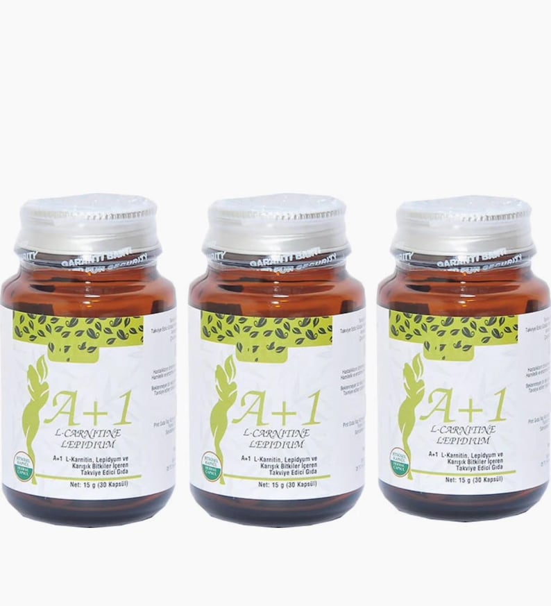 May include: Three brown glass bottles with silver lids and white labels. The labels feature the text "A+1 L-CARNITINE LEPIDIUM" and a green graphic. Each bottle is sealed with a silver band that reads "GARANTI BAN".