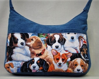 Dogs medium handbag in blue denim with mobile phone pocket in front with 2 pockets. Back zip pocket 2 inside pockets