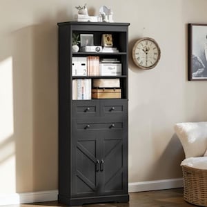 May include: A tall, black wooden storage cabinet with multiple shelves, drawers, and a lower cabinet with a barn door design. The cabinet is filled with books, boxes, and decorative items. A vintage-style clock hangs on the wall.