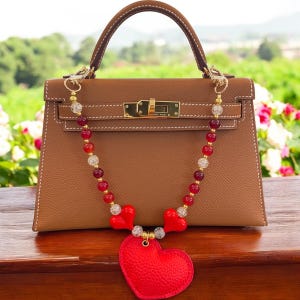 Charm para bolso de corazón de cuero vegano con cuentas de vidrio rojas y detalles dorados