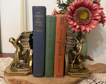 Pair of vintage "Struggling Librarian"brass bookends by PM Craftsman