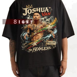 May include: Black t-shirt with a graphic of a man, lightning bolts, and the text "JOSHUA VAN" and "the FEARLESS". The shirt also includes the text "8IGHT" and "HOUSTON TEXAS".