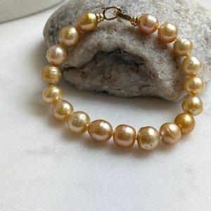 Elly’s 9-10mm 18pcs Genius South sea golden Ocean Pearls bracelet: Extreme luster, gold to deep golden pearls, 8”, S925 silver bracelet.