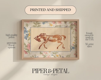 May include: Framed art print featuring a brown horse illustration on a cream background, surrounded by floral patterned fabric. The frame is light-colored. Text on the image reads "PRINTED AND SHIPPED" and "PIPER & PETAL vintage designs."