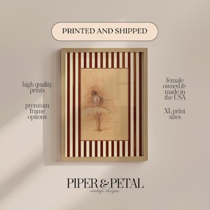May include: Framed print of a ballerina sketch. The artwork is in a light brown frame with a striped border. The text "PRINTED AND SHIPPED" is at the top, and "PIPER & PETAL vintage designs" is at the bottom. Additional text includes "high quality prints" and "XL print sizes."