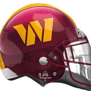 May include: A maroon and gold football helmet balloon with a white 'W' logo. The helmet has a silver face mask.