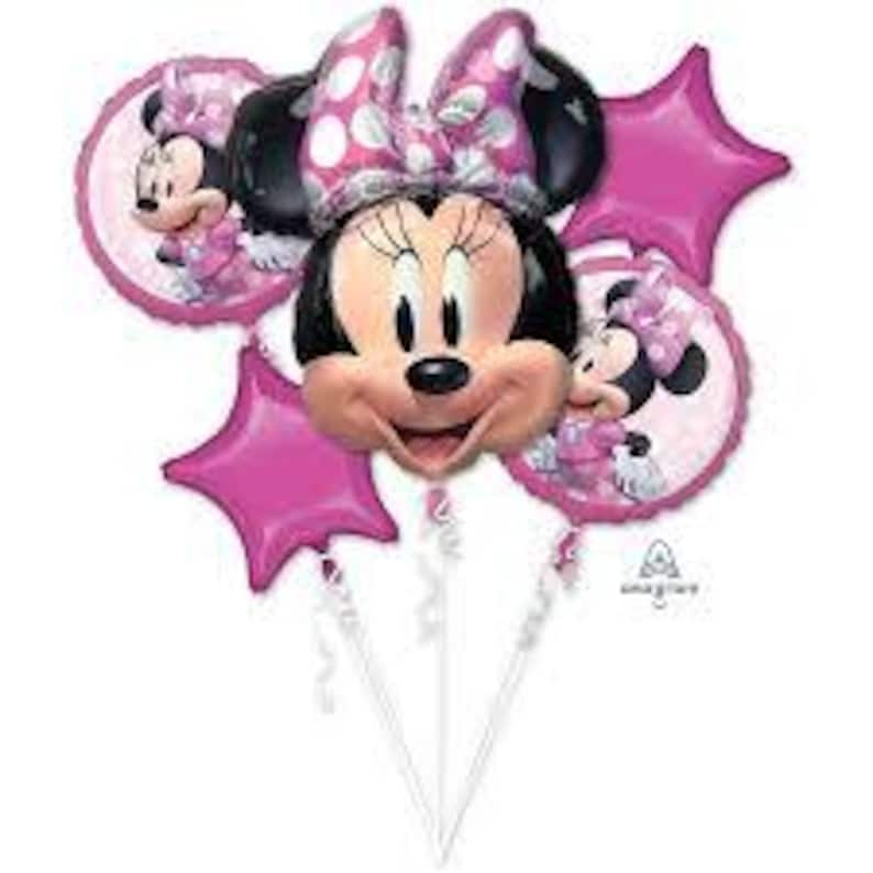 Puede incluir: Un conjunto de cinco globos de Minnie Mouse de color rosa y blanco. Los globos presentan la cara de Minnie Mouse, una estrella rosa y dos globos redondos con la imagen de Minnie Mouse.