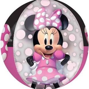 May include: A pink and white polka dot balloon with a cartoon image of Minnie Mouse. Minnie Mouse is wearing a pink dress with white polka dots and a white bow.