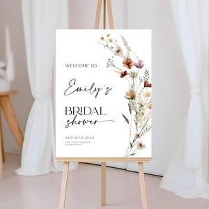Bridal shower welcome sign template with boho watercolor wildflowers in warm earthy tones, featuring elegant mix of script and serif fonts on a clean white background, fully editable in Canva.