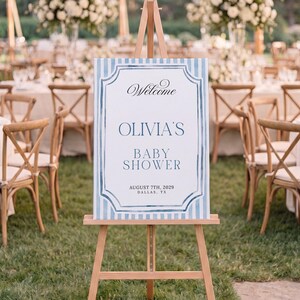 Editable blue striped baby shower welcome sign template with watercolor border, classic frame details, and elegant script lettering.