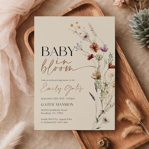 Editable Baby in Bloom baby shower invitation with watercolor wildflowers and boho floral design on a neutral background.
