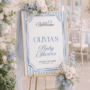 Editable blue striped baby shower welcome sign template with watercolor border, classic frame details, and elegant script lettering.