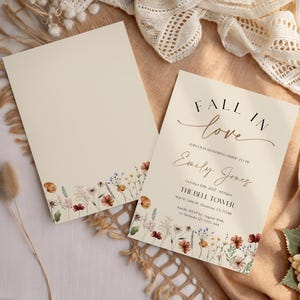 Fall in Love" bridal shower invitation with modern calligraphy, autumn wildflowers border, and minimalist neutral background.