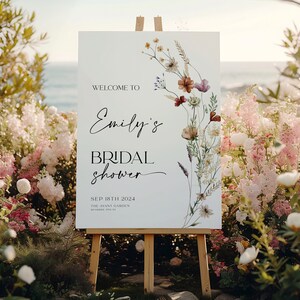 Bridal shower welcome sign template with boho watercolor wildflowers in warm earthy tones, featuring elegant mix of script and serif fonts on a clean white background, fully editable in Canva.