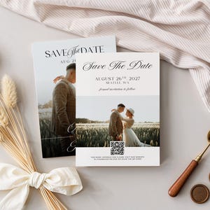 May include: Two wedding Save the Date cards with a photo of a couple. The cards have elegant script and the date August 26th, 2027. A bouquet of dried flowers and a wax seal set with a spoon are also in the image.