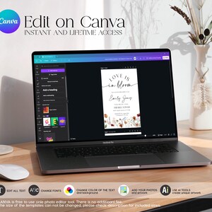 May include: A laptop displays a wedding invitation template with the text "Love is in bloom." The screen shows the Canva editing interface. The laptop is on a wooden desk, with a white mouse and a vase of dried flowers in the background. Text on the screen says "Edit on Canva."