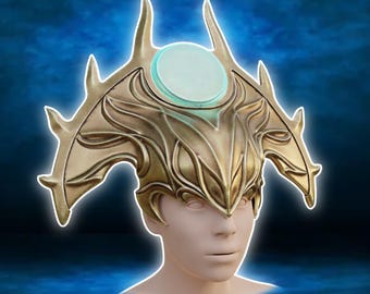 May include: A gold-colored Shar Crown with a central light blue gem. The crown has intricate, stylized details and sharp points. The text "Shar Crown" is at the top, and "3D printer files Digital product" is at the bottom.