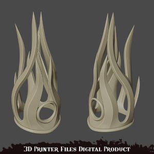 K&ouml;nnte beinhalten: Ein 3D-druckbares Modell einer Krone mit Flammen-Design. Die Krone besteht aus einem einzigen St&uuml;ck Material und hat einen Ring an der Basis.
