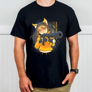 May include: Black t-shirt featuring a cartoon anime character with fox ears, wearing a yellow hoodie and holding a large weapon. The character has yellow eyes and black hair. Japanese text is visible on the right side of the graphic.